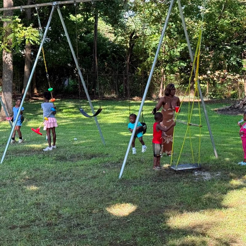 Children playing on the swings during the picnic