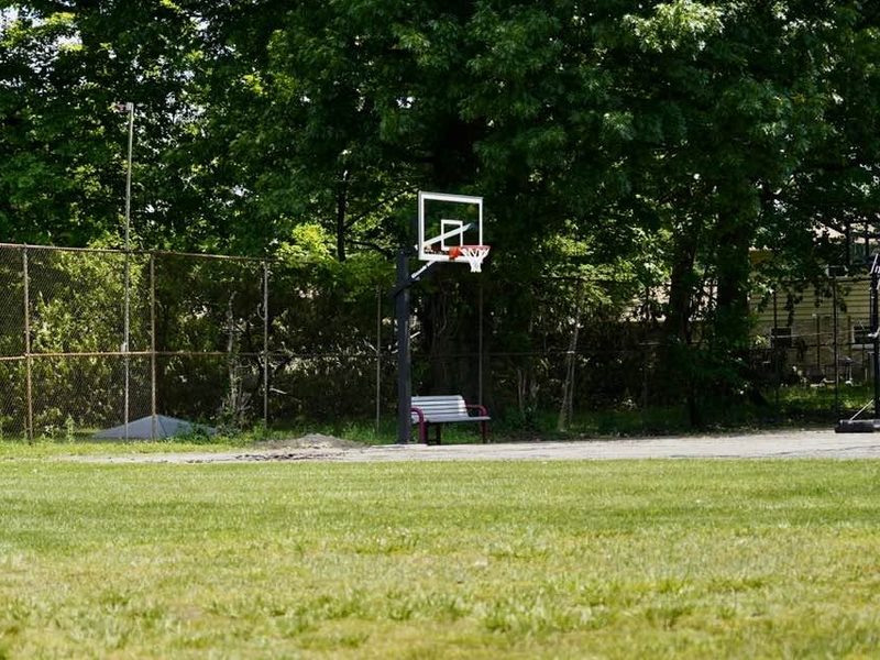 A basketball hoop on the existing court